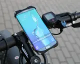 Jaki uchwyt na telefon do roweru? Samsung Galaxy S6 edge+ zamontowany na kierownicy roweru, obok licznika.