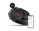 Silnik Bosch Performance CX Gen 5 do e-bike'a, gotowy na aktualizację. Obok smartfon z aplikacją Bosch eBike Flow.