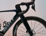 Ciemnoniebieski rower Scott z aerodynamicznym mostkiem i kierownicą. Koła z oponami Schwalbe Pro One.