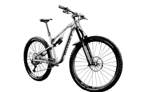 Srebrny rower górski, idealny na trudne trasy. Czy to rower crossowy czy mtb? Zdecydowanie ten drugi, gotowy na każde wyzwanie.