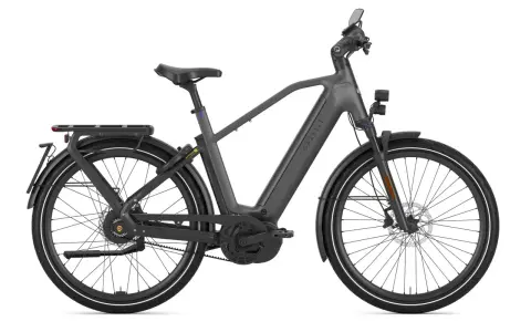 Szary rower elektryczny Gazelle z bagażnikiem i oświetleniem, jeden z najszybszych rowerów elektrycznych na rynku.