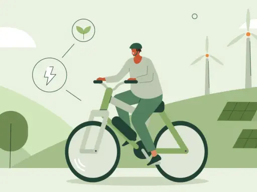 Mężczyzna na rowerze elektrycznym, symbolizującym ekologiczne podróże i duży zasięg. W tle farmy wiatrowe i panele słoneczne.