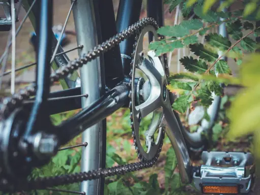 Zbliżenie na mechanizm korbowy i łańcuch rowerowy. Różne rodzaje łańcuchów rowerowych zapewniają płynną jazdę.