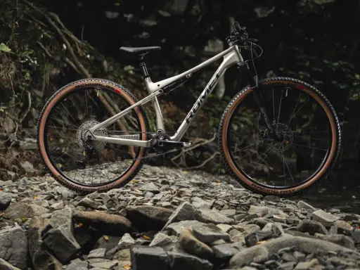 Gotowy na przygodę xc rower Romet z brązowymi oponami na kamienistym szlaku.